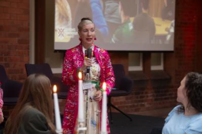 Lady in colourful jacket at lectern